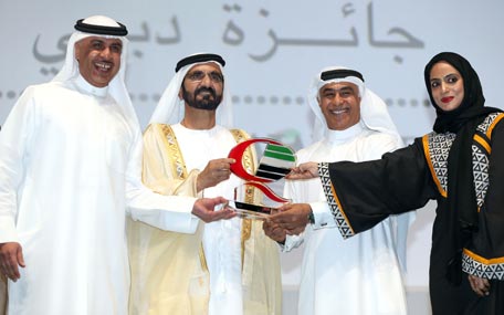 Sheikh Mohammed bin Rashid honouring a winner of Dubai Quality Awards on Monday. (Wam)