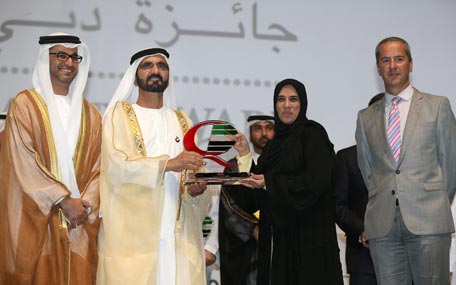 Sheikh Mohammed bin Rashid honouring a winner of Dubai Quality Awards on Monday. (Wam)