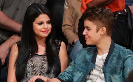 Selena Gomez (L) and Justin Bieber attend a basketball game between the San Antonio Spurs and the Los Angeles Lakers at Staples Center on April 17, 2012 in Los Angeles, California. (Getty)