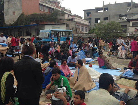 Patients wait at the parking lot of Norvic International Hospital after an earthquake hit Kathmandu, Nepal, Saturday, April 25, 2015. A powerful, magnitude-7.9 earthquake shook Nepal's capital and the densely populated Kathmandu Valley before noon Saturday, collapsing houses, leveling centuries-old temples and cutting open roads in the worst temblor in the Himalayan nation in over 80 years. (AP)