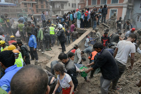 People clear rubble in Kathmandu's Durbar Square, a UNESCO World Heritage Site that was severely damaged by an earthquake on April 25, 2015. (AFP)