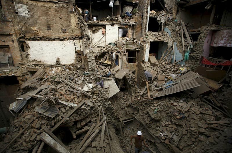 People search for family members trapped inside collapsed houses a day after an earthquake in Bhaktapur, Nepal April 26, 2015. Rescuers dug with their bare hands and bodies piled up in Nepal on Sunday after the earthquake devastated the crowded Kathmandu valley, killing at least 2,200, and triggered a deadly avalanche on Mount Everest.  (Reuters)