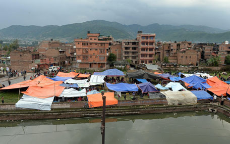 Nepalese people stay outside in tents in Bhaktapur on the outskirts of Kathmandu on April 26, 2015. (AFP)