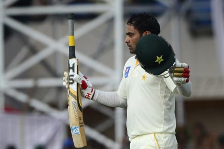 Pakistan cricketer Mohammad Hafeez celebrates scoring a century (100 runs) during the second day of the first cricket Test match between Bangladesh and Pakistan at The Sheikh Abu Naser Stadium in Khulna on April 29, 2015. AFP