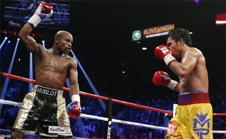 Floyd Mayweather Jr (left) celebrates during his welterweight title fight against Manny Pacquiao, from the Philippines, on Saturday, May 2, 2015 in Las Vegas. (AP)