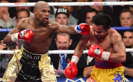 Floyd Mayweather Jr (left)  connects against Manny Pacquiao during their welterweight unification bout on May 2, 2015 at the MGM Grand Garden Arena in Las Vegas, Nevada. (AFP)