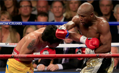 Floyd Mayweather Jr (right) throws a right at Manny Pacquiao during their welterweight unification championship bout on May 2, 2015 at MGM Grand Garden Arena in Las Vegas, Nevada. (AFP)