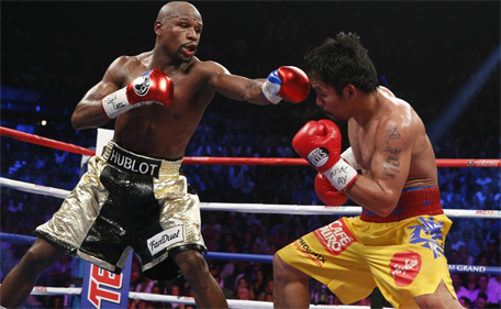 US boxer Floyd Mayweather Jr (left) and Manny Pacquiao of the Philippines fight during their welterweight unification boxing bout at the MGM Grand Garden Arena in Las Vegas, Nevada on May 2, 2015. (AFP)