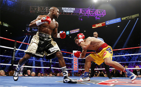 US boxer Floyd Mayweather Jr (left) and Manny Pacquiao of the Philippines fight during their welterweight unification boxing bout at the MGM Grand Garden Arena in Las Vegas, Nevada on May 2, 2015. (AFP)