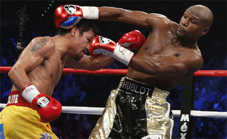 US boxer Floyd Mayweather Jr (right) and Manny Pacquiao of the Philippines fight during their welterweight unification boxing bout at the MGM Grand Garden Arena in Las Vegas, Nevada on May 2, 2015. (AFP)