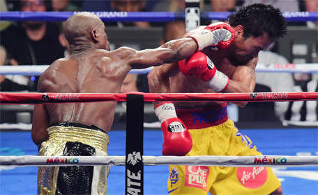 Floyd Mayweather Jr of the US goes after Manny Pacquiao (left) of the Philippines during their welterweight WBO, WBC and WBA (Super) title fight in Las Vegas, Nevada, May 2, 2015. (Joe Camporeale-USA TODAY Sports)