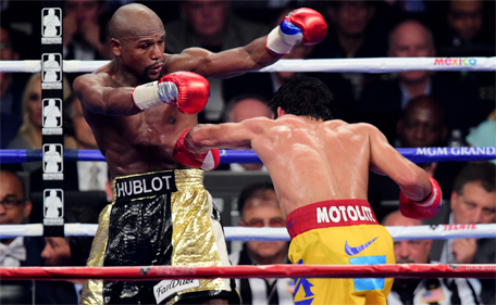 Floyd Mayweather (left) and Manny Pacquiao box during their world welterweight championship bout at MGM Grand Garden Arena. (Joe Camporeale-USA TODAY Sports)
