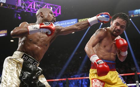 Floyd Mayweather Jr., hits Manny Pacquiao during their welterweight title fight in Las Vegas. (AP)