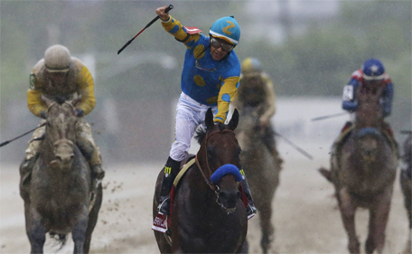 American Pharoah, ridden by Victor Espinoza, center, celebrates after winning the 140th Preakness Stakes horse race at Pimlico Race Course, Saturday, May 16, 2015, in Baltimore. (AP)
