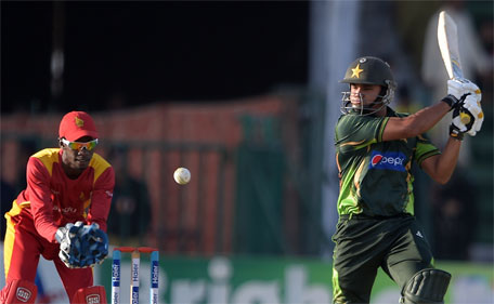 Pakistani captain Azhar Ali (right) plays a shot as Zimbabwean wicketkeeper Richmond Mutumbami looks on during the first one day international cricket match between Pakistan and Zimbabwe at the Gaddafi Cricket Stadium in Lahore on May 26, 2015. (AFP)