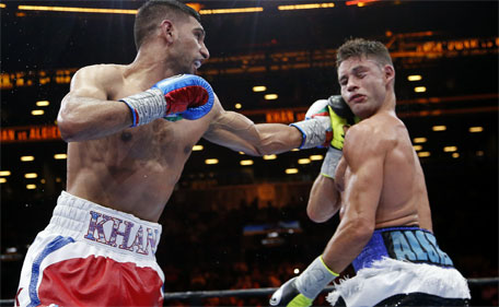 Amir Khan (left) lands a left to Chris Algieri during the eighth round of a boxing bout Friday, May 29, 2015, in New York. (AP)
