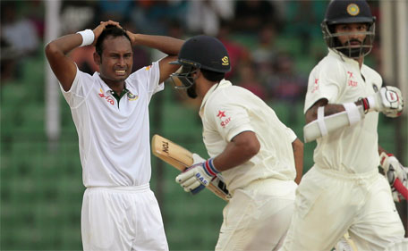 Bangladesh’s Mohammad Shahid (left) reacts as India’s Murali Vijay (centre) and Shikhar Dhawan run between wickets during the one-off Test in Fatullah, Bangladesh, Wednesday, June 10, 2015. (AP)