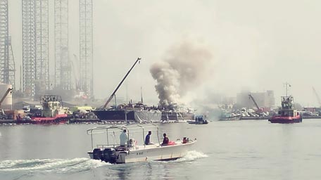 A cargo boat loaded with foodstuffs, fuel and other products caught fire near Port Khalid in Sharjah on Tuesday morning. (Image courtesy Basheer Marancherry)