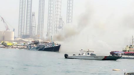 A cargo boat loaded with foodstuffs, fuel and other products caught fire near Port Khalid in Sharjah on Tuesday morning. (Image courtesy Basheer Marancherry)