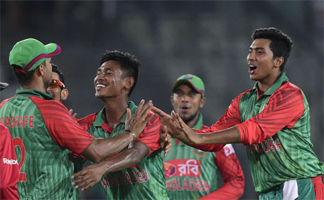 Bangladesh cricketers congratulate teammate Mustafizur Rahman (second right) after the dismissal of Indian cricketer Rohit Sharma during the first One Day International cricket match between Bangladesh and India at The Sher-e-Bangla National Cricket Stadium in Dhaka on June 18, 2015. (AFP)
