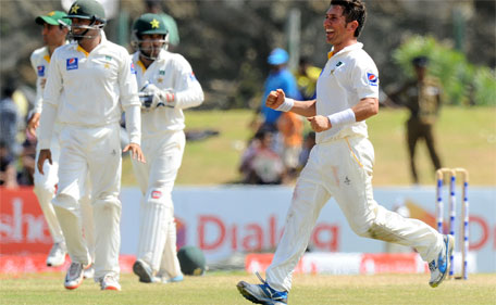Pakistan spinner Yasir Shah (right) celebrates the dismissal of Sri Lankan cricketer Rangana Herath during the final day of the opening Test match between Sri Lanka and Pakistan at the Galle International Cricket Stadium in Galle on June 21, 2015. (AFP)