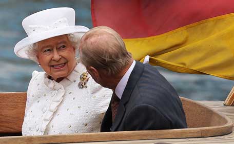 Britain's Queen Elizabeth II and her husband Prince Philip, The Duke of Edinburgh are seen during a boat trip on the River Spree to the chancellery in Berlin on June 24, 2015. Britain's Queen Elizabeth II is in Germany for a three-day visit. Her agenda includes a meeting with German Chancellor Angela Merkel and a visit at the former Nazi concentration camp Bergen-Belsen. (AFP)