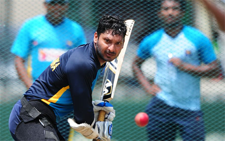 Sri Lanka's cricketer Kumar Sangakkara eyes the ball as he plays a shot during a practice session at the P. Sara Oval Cricket Stadium in Colombo on June 24, 2015, ahead of a second Test match against Pakistan on June 25. (AFP)