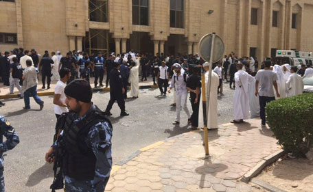 Security forces, officials and civilians gather outside the mosque after a deadly blast struck after Friday prayers in Kuwait City, Kuwait, Friday, June 26, 2015.  (AP)