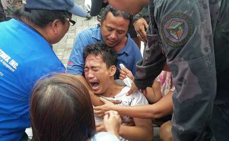 A survivor of a passenger ferry that capsized in rough waters cries after arriving at the pier in Ormoc City, central Philippines on July 2, 2015. At least 36 people were killed after a passenger ferry with close to 200 people on board capsized in rough waters in the central Philippines on July 2, officials said.  (AFP)
