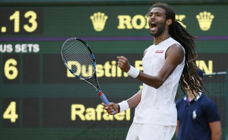 Dustin Brown of Germany celebrates after breaking serve in fourth set during his match against Rafael Nadal of Spain at the Wimbledon Tennis Championships in London, July 2, 2015. (Reuters)