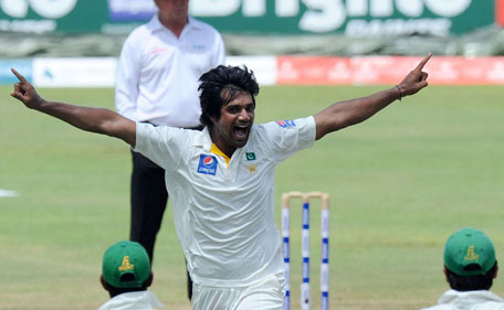 Pakistan bowler Rahat Ali claims the wicket of Sri Lanka batsman Dimuth Karunaratne on day three of the 3rd Test at Pallekele on July 5, 2015. (AFP)