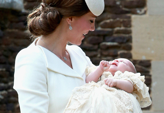 Britain's Catherine, Duchess of Cambridge, carries her daughter, Princess Charlotte of Cambridge as they arrive for Charlotte's Christening at St. Mary Magdalene Church in Sandringham, England, on July 5, 2015. Crowds gathered outside Queen Elizabeth II's country residence on Sunday for the christening of Britain's baby Princess Charlotte, who it was announced will have five godparents. (AFP)