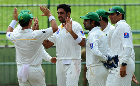 Pakistan bowler Imran Khan (centre) celebrates with his teammates after he dismissed Sri Lankan batsman Dhammika Prasad during the fourth day of the third and final Test cricket match between Sri Lanka and Pakistan at the Pallekele International Cricket Stadium in Pallekele on July 6, 2015. (AFP)