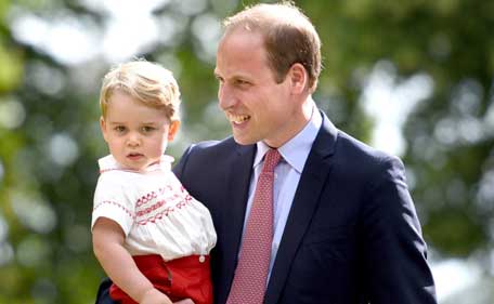 Prince George of Cambridge (L) and father Prince William, Duke of Cambridge as they walk past the crowds as they leave Charlotte's Christening at St. Mary Magdalene Church in Sandringham, England, on July 5, 2015. Britain's baby Princess Charlotte was christened on Sunday in her second public outing since her birth nine weeks ago to proud parents Prince William and his wife Kate. (AFP)