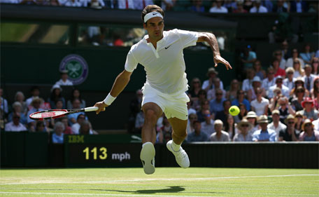 Switzerland's Roger Federer returns against Australia's Samuel Groth during their men's singles third round match on day six of the 2015 Wimbledon Championships at The All England Tennis Club in Wimbledon, London, on July 4, 2015. (AFP)