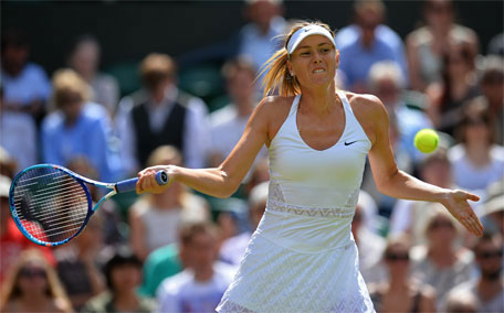 Russia's Maria Sharapova returns to US player Coco Vandeweghe during their women's quarter-finals match on day eight of the 2015 Wimbledon Championships at The All England Tennis Club in Wimbledon, southwest London, on July 7, 2015. (AFP)