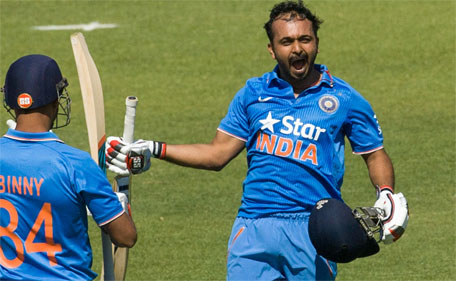Indian batsman Kedar Jadhav celebrates with Stuart Binny after reaching 100 runs in the third and final one-day international between India and Zimbabwe at Harare Sports Club on July 14 2015. (AFP)