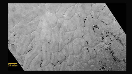 In the center left of Pluto’s vast heart-shaped feature – informally named ‘Tombaugh Regio’ - lies a vast, craterless plain that appears to be no more than 100 million years old. This frozen region is north of Pluto’s icy mountains and has been informally named Sputnik Planum (Sputnik Plain), after Earth’s first artificial satellite. (Nasa)