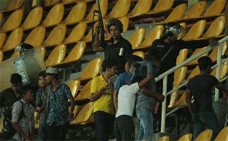 Sri Lankan riot police officers lead  spectators out of the stands following a clash during the third one day international cricket match between Sri Lanka and Pakistan in Colombo, Sri Lanka, Sunday, July 19, 2015. (AP)