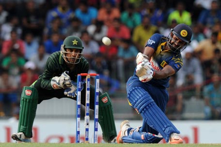 Sri Lankan cricketer Lahiru Thirimanne (R) is watched by Pakistan wicketkeeper Sarfraz Ahmed as he plays a shot during the fourth One Day International (ODI) cricket match between Sri Lanka and Pakistan at the R Premadasa International Cricket Stadium in Colombo on July 22, 2015. AFP