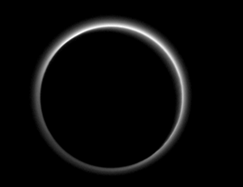 Backlit by the sun, Pluto's atmosphere rings its silhouette like a luminous halo in this image taken by New Horizons spacecraft around midnight EDT on July 15. This global portrait of the atmosphere was captured when the spacecraft was about 1.25 million miles from Pluto and shows structures as small as 12 miles across. (Credits: Nasa/JHUAPL/SwRI)