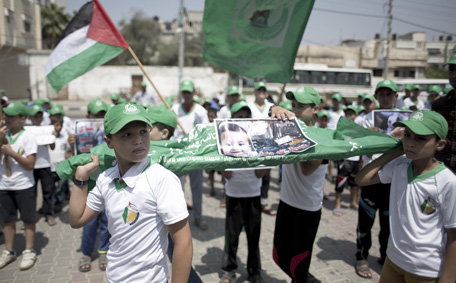 Palestinian children carry a funeral stretcher with a picture of 18-month-old Ali Saad Dawabsha, the toddler who was burned to death by suspected Jewish extremists, on August 1, 2015 in Khan Yunis in the southern Gaza Strip. The parents and brother of the Palestinian toddler are fighting for their lives, as protests over the arson attack in the occupied West Bank entered a second day.  (AFP)