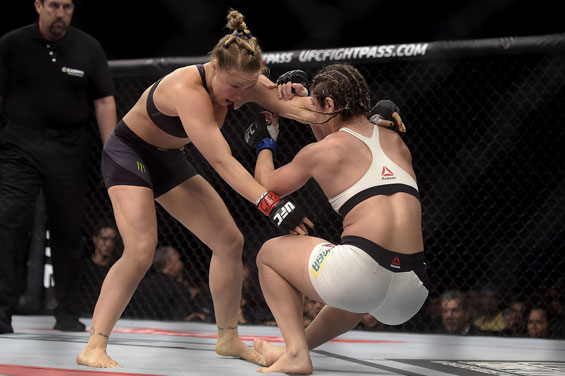 Ronda Rousey, left, of the United States, battles Brazil's Bethe Correia during their mixed martial arts bantamweight title fight at UFC 190 in Rio de Janeiro, Brazil. (AP)