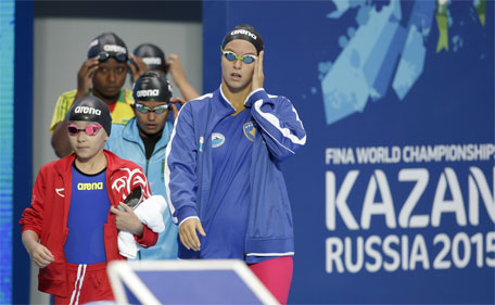 Alzain Tareq (left) from Bahrain enters the hall before competing in a women's 50m butterfly heat at the Swimming World Championships in Kazan, Russia, Friday, Aug. 7, 2015. (AP)
