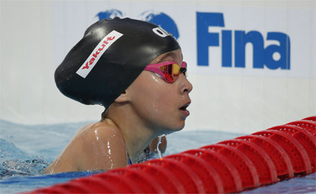 Ten-years-old Alzain Tareq from Bahrain leaves the pool after competing in a women's 50m butterfly heat at the Swimming World Championships in Kazan, Russia, Friday, Aug. 7, 2015. (AP)