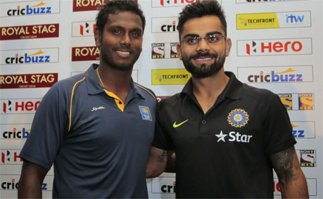 Sri Lanka's captain Angelo Mathews (left) and his Indian counterpart Virat Kohli pose for photographers during a press conference ahead of their three-Test match series in Colombo, Sri Lanka, Wednesday, Aug. 5, 2015. (AP)