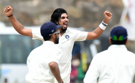 Indian bowler Ishant Sharma (centre) celebrates after dismissing Sri Lankan batsman Dimuth Karunaratne during the first day of the opening Test cricket match between Sri Lanka and India at The Galle International Cricket Stadium in Galle on August 12, 2015. (AFP)