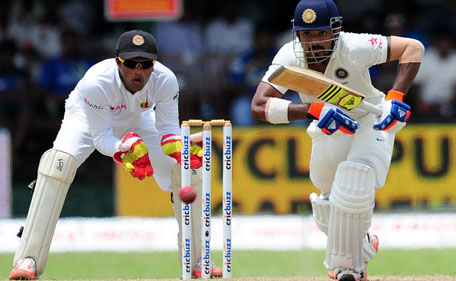 Indian cricketer Lokesh Rahul (right) plays a shot as Sri Lankan wicketkeeper Dinesh Chandimal look on during the opening day of their second test match between Sri Lanka and India at the P. Sara Oval Cricket Stadium in Colombo on August 20, 2015. (AFP)