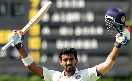 Indian cricketer Lokesh Rahul raises his bat and helmet in celebration after scoring a century (100 runs) during the opening day of their second test match between Sri Lanka and India at the P. Sara Oval Cricket Stadium in Colombo on August 20, 2015. (AFP)