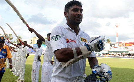 Sri Lankan cricketer Kumar Sangakkara walks back to the pavilion after his dismissal during the fourth day of their second Test cricket match between Sri Lanka and India at the P. Sara Oval Cricket Stadium in Colombo on August 23, 2015. (AFP)